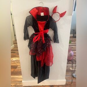 Spirit girl’s Devil costume size medium and includes headband with devil horns